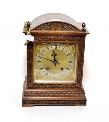 Lot 143 - An oak quarter striking mantel clock, movement stamped W&H, retailed by Bowman Limited, London,...