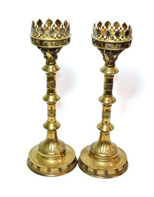 Lot 150 - ^ A pair of brass ecclesiastical candlesticks, 50cm high