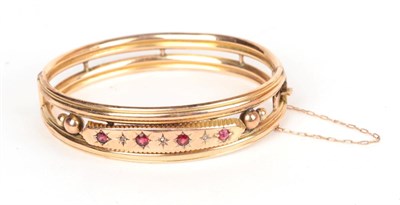 Lot 176 - A garnet and rose cut diamond set bangle, stamped '9' '.375', measures 6cm by 4.8cm