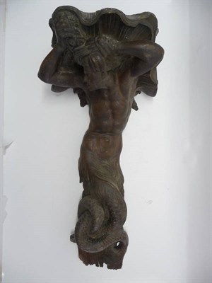 Lot 1212 - A Carved Oak Figural Corbel, 19th century, as a merman supporting a conch shell, 76cm high