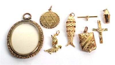 Lot 196 - Nine charms/pendants, including two 9 carat gold examples, an 18 carat gold bird example, a...