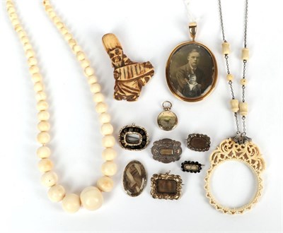 Lot 207 - Seven mourning brooches, in varying states of repair; a locket; a netsuke; a magnifying glass...