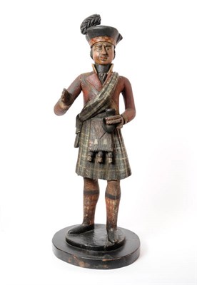 Lot 1215 - A Carved and Painted Tobacconist Shop Figure, circa 1800, as a Highlander in black feathered...