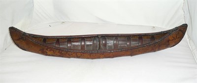 Lot 1216 - A North American Indian Birch Bark Model of a Canoe, the one piece bark skin lined with overlapping