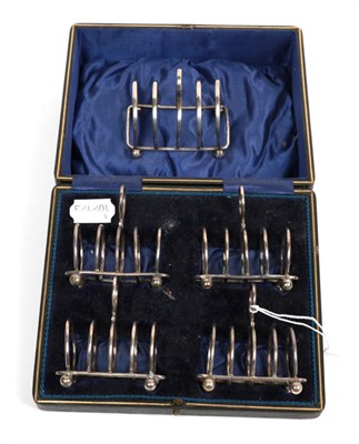 Lot 318 - A silver toast rack and a cased set of four toast racks