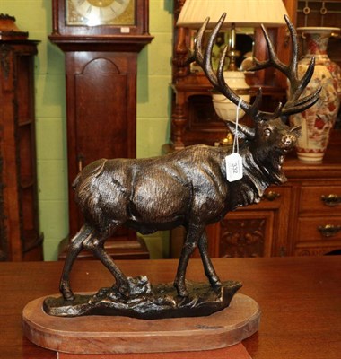 Lot 332 - A modern bronzed figure of a stag standing on a rocky base