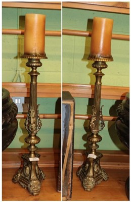 Lot 335 - ^ A pair of Victorian brass candlesticks, 54cm high