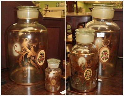 Lot 341 - ^ A graduated set of four glass and gilt decorated storage jars with lids, the largest 46cm