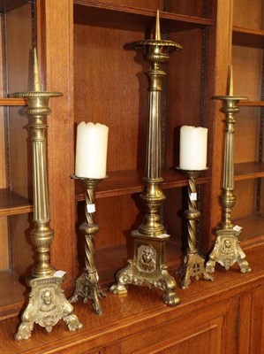 Lot 346 - ^ A pair of Victorian brass pricket candlesticks, 66cm high; a large example, 79cm high; and a pair