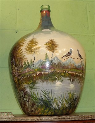 Lot 348 - ^ A glass carboy painted with swans and doves amongst a landscape, 54cm high