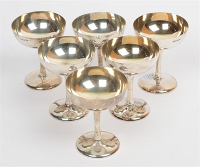 Lot 357 - A set of six silver champagne saucers, Walker & Hall, Sheffield 1913, 10.5cm high, 19.9ozt (6)