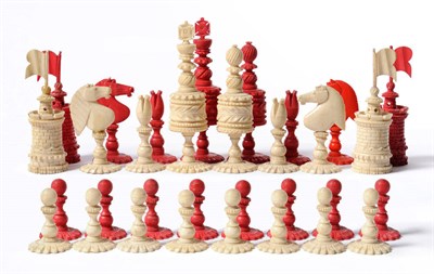 Lot 1230 - An Ivory and Stained Ivory Chess Set, 19th century, on floriform circular bases, the kings...