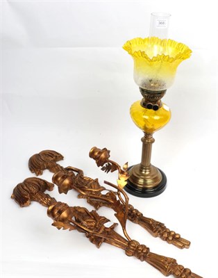 Lot 368 - ^ A late Victorian brass oil lamp with yellow tinted glass reservoir and later etched glass...