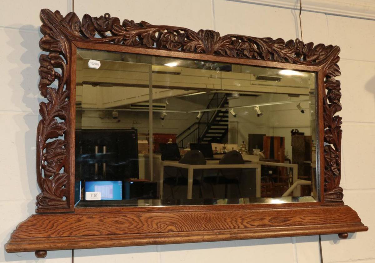 Lot 1151 - ^ A Victorian carved oak bevelled glass over mantle mirror, 63cm by 111cm
