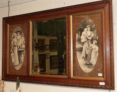 Lot 1154 - ^ An early 20th century oak bevelled glass mirror, flanked by two oval black and white prints, 67cm