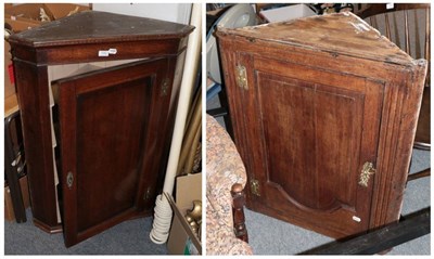 Lot 1185 - ^ A George III oak and mahogany crossbanded hanging corner cupboard; together with another...