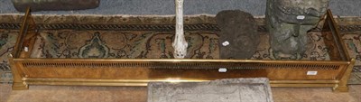 Lot 1196 - Brass fire curb with Egyptian decoration and obelisk form corners, 139.5cm wide