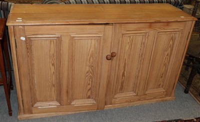 Lot 1204 - A pitch pine cabinet with two cupboard doors, 155cm wide