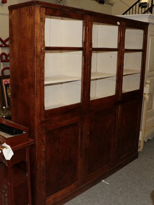 Lot 1228 - An early 20th century kitchen cupboard the upper section with three glazed doors and three cupboard