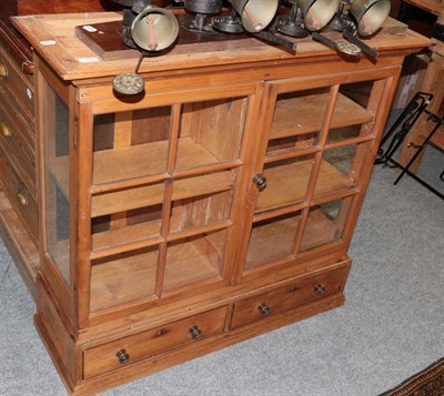 Lot 1239 - ^ A glazed pine cabinet