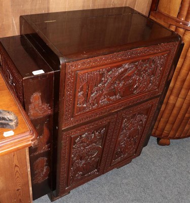 Lot 1246 - ^ A mid-20th century Oriental carved drinks cabinet