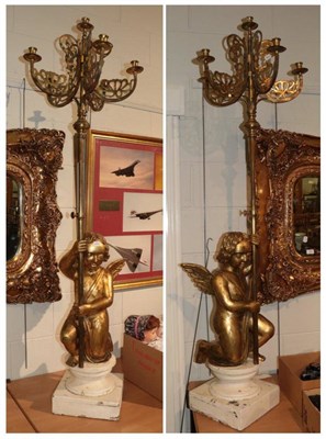 Lot 1286 - ^ A pair of brass five branch ecclesiastical style candelabrums, the bases with carved giltwood...
