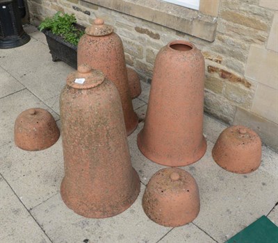 Lot 1302 - ^ Three terracotta rhubarb bell shaped forcing pots, one lacking cover, 77cm excluding lids;...