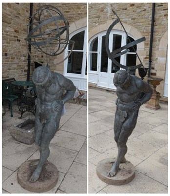 Lot 1309 - ^ A pair of reproduction metal gardren ornaments modelled as male figures holding  an armillary...