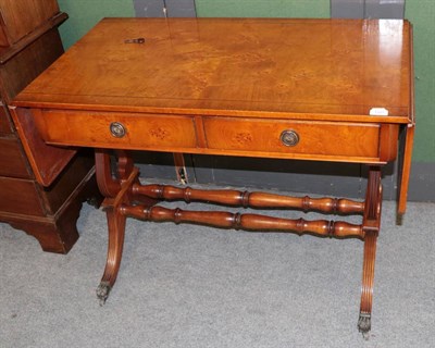 Lot 1317 - A reproduction yew wood sofa table