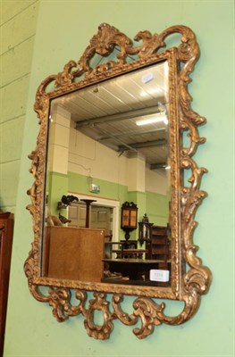 Lot 1319 - A composition gilt bevelled glass mirror, 79cm high