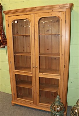 Lot 1326 - ^ A pine glazed bookcase, 200cm high