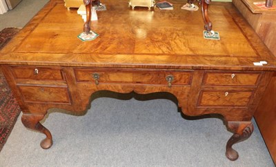 Lot 1332 - An oak lined walnut writing table in George I style