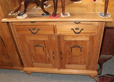 Lot 1333 - ^ A late 19th century pine sideboard, with pull out slide, two drawers and two cupboard doors,...