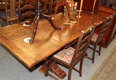 Lot 1345 - A carved oak drawer leaf refectory style table and four ladder back chairs