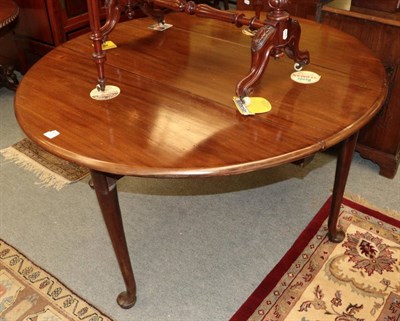 Lot 1350 - A Georgian mahogany drop leaf dining table on pad feet