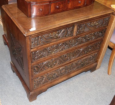 Lot 1355 - ^ A George III oak chest, later carved, with two short over three long drawers, 87cm wide