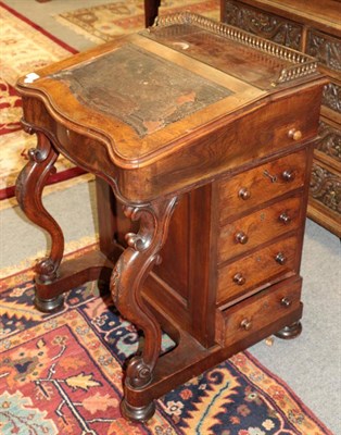 Lot 1357 - ^ A Victorian figured walnut Davenport, with pierced brass gallery