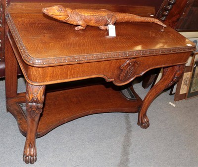 Lot 1360 - A late 19th century serving table on carved cabriole legs, joined by a serpentine shelf with...