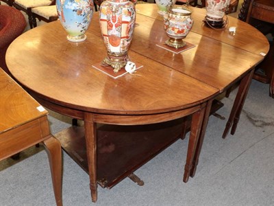 Lot 1361 - A George III mahogany dining table with two additional leaves