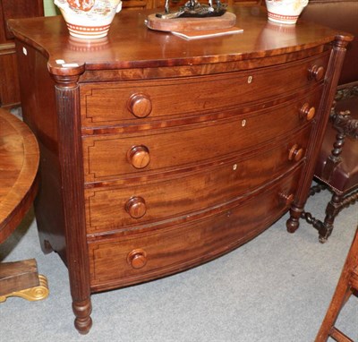 Lot 1364 - A mahogany bow fronted and ebony strung chest of drawers, circa 1820, with reeded columns,...