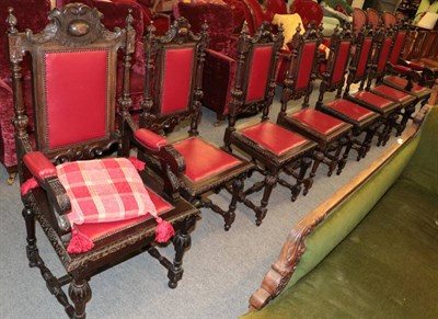 Lot 1382 - ^ A set of eight late Victorian carved oak armchairs including two carvers covered in close...