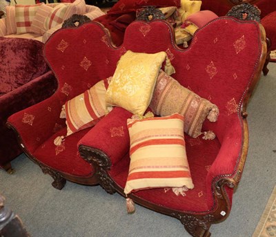 Lot 1383 - ^ A late 19th century two seater sofa, with carved frame and recovered in red close nailed...