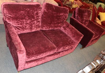 Lot 1384 - ^ A modern two seater sofa upholstered in red plush fabric, 137cm wide; and a matching...