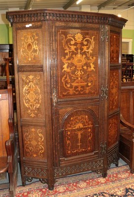 Lot 1388 - ^ An oak and marquetry inlaid wardrobe circa 1900, with a dentil cornice and cupboard door,...