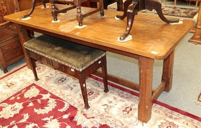 Lot 1392 - ^ A late 19th/early 20th century oak dining table raised on square chamfered legs, joined by an...