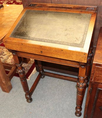 Lot 1396 - ^ A late Victorian oak writing desk, with leather hinged lid, with turned and carved legs, 57cm...