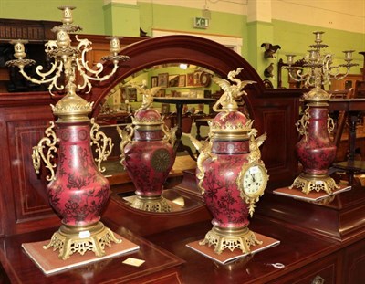 Lot 1404 - ^ A Chinese style striking mantle clock garniture, circa 1900, the vase form case with applied gilt