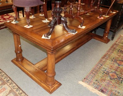 Lot 1406 - An oak dining table, modern, on gun barrel legs