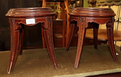 Lot 1412 - ^ A pair of mahogany and polychrome painted circular stands, with moulded top and spade legs,...