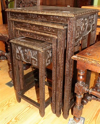 Lot 1418 - ^ A nest of four early 20th century carved nesting tables in the Oriental style, largest table 53cm